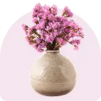 Home decor items including cushions and vases arranged on a wooden table in a cozy living room, evoking a warm and inviting atmosphere